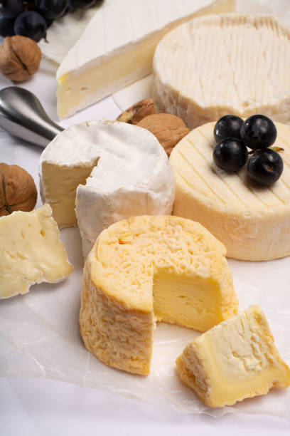 istock French AOC soft cow cheeses, crumbly Langres with washed rind structure, sharp Pie Angloys, camembert with strong taste and brie served as dessert after dinner 1014194454