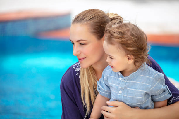 istock Happy mother with little son on the beach resort 1014197848