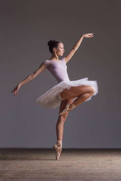 istock Young beautiful ballerina is posing in studio 1014197950