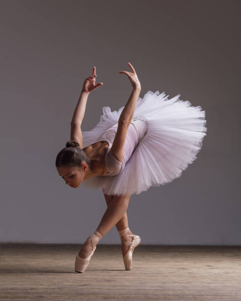 istock Young beautiful ballerina is posing in studio 1014198048