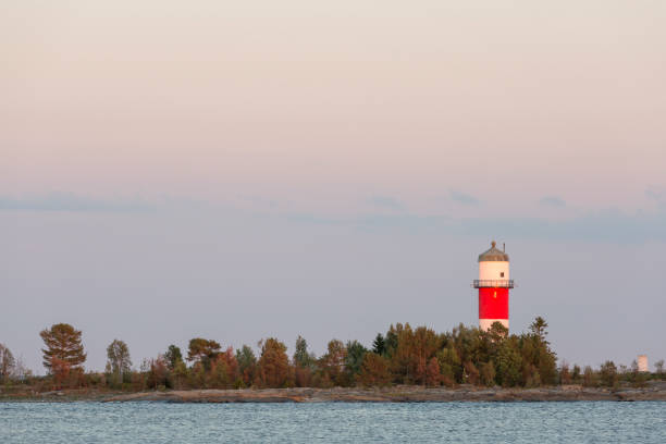 istock Light House with trees and Ocean 1014198138