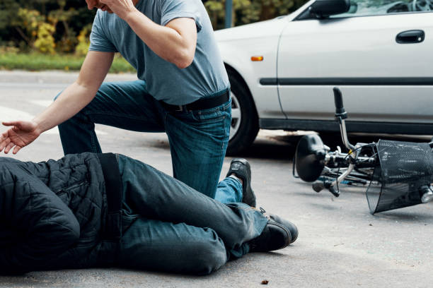 istock Car driver making emergency call after collision with a cyclist on the street 1014198230