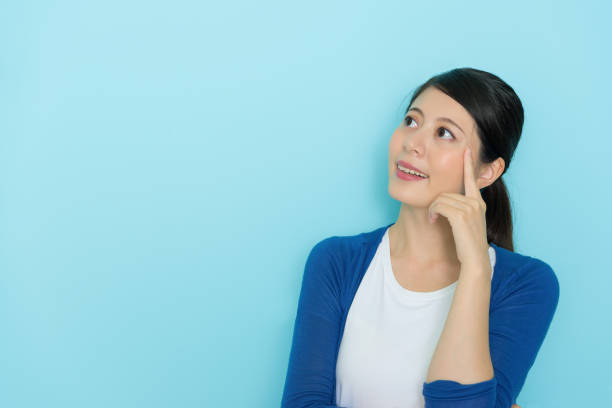istock beautiful pretty woman looking at empty area 1014206326