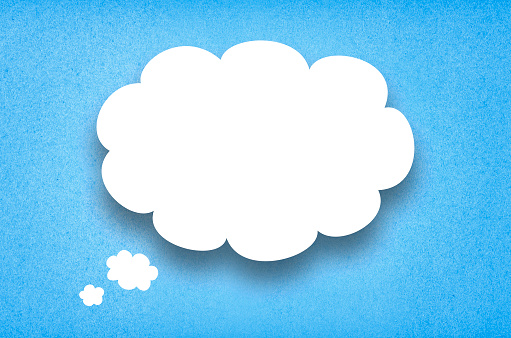 White paper thought bubble. White paper cloud with blue cardboard background.