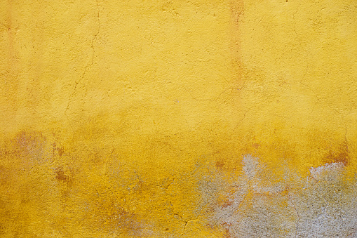 Colourful yellow textured wall in San Miguel de Allende in Mexico