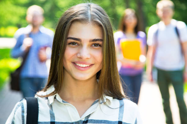 istock Female students outdoors with her friends 1014213152
