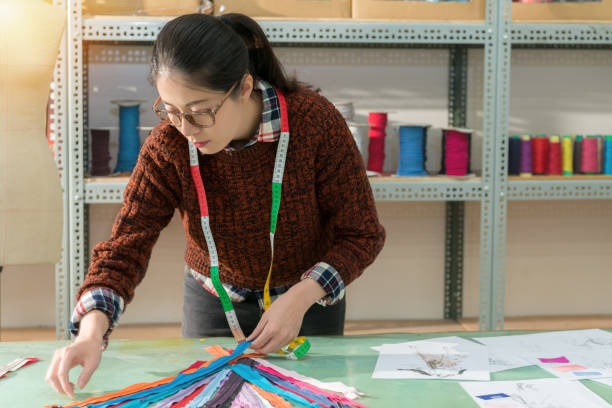 istock female clothing maker sort out many color zipper 1014215812