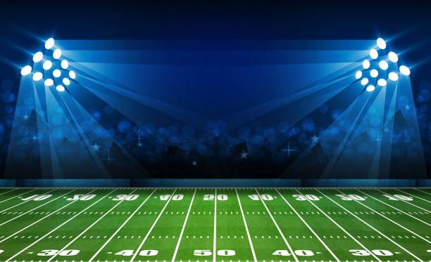 istock American football arena field with bright stadium lights design. Vector illumination 1014216440