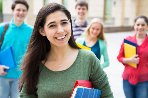 istock Female student outdoors with her friends 1014216504