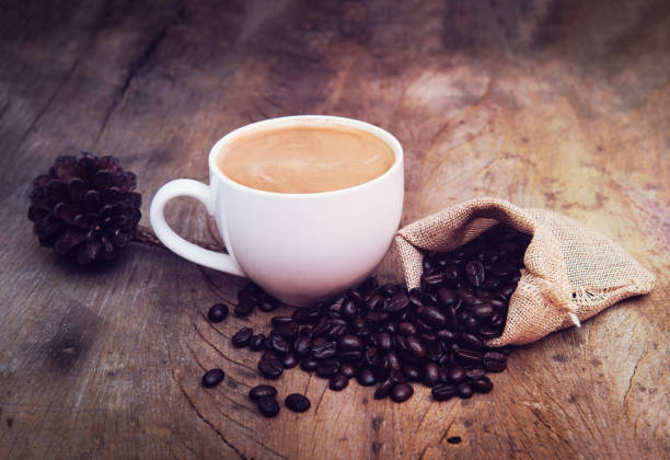 istock coffee in white cup with coffee beans on wooden table 1014219656
