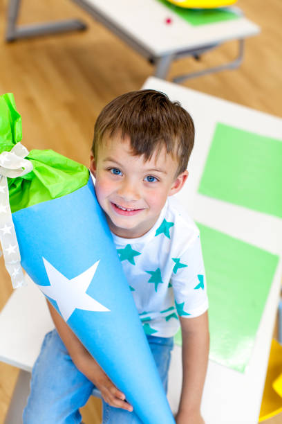 istock pretty, blond Schoolboy on the first day of school with a candy cone 1014220412