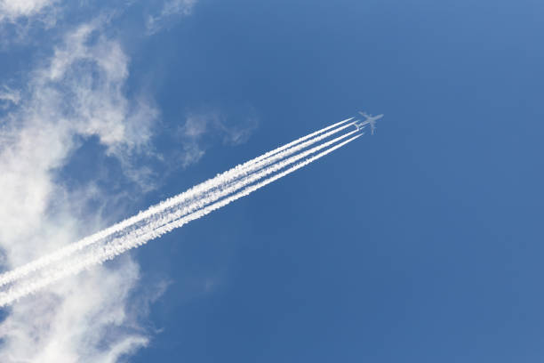 istock Airplane in cloudy sky with an inverse trace 1014224484