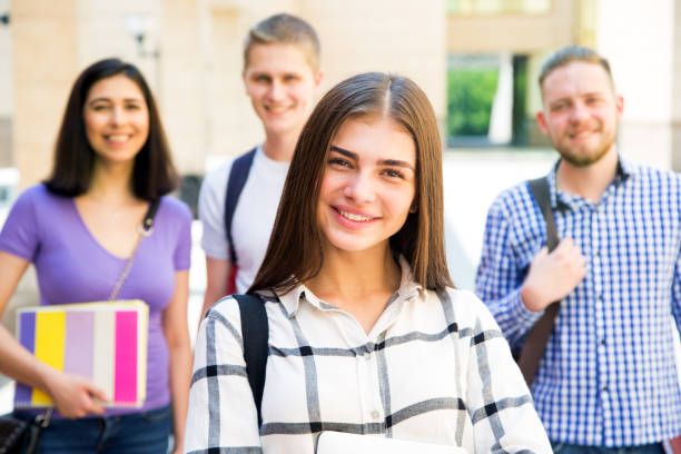 istock Female student outdoors with her friends 1014224786