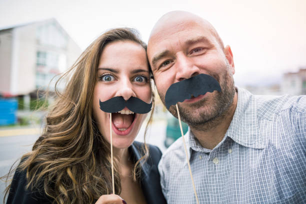 istock Couple taking funny selfie with black mustaches 1014225260