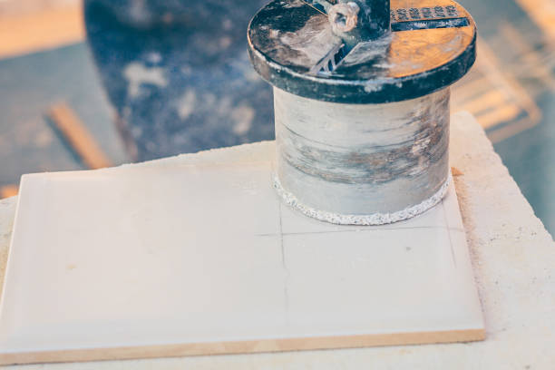 istock Finishing works - the tiler cuts the tile with a diamond crown 1014231886