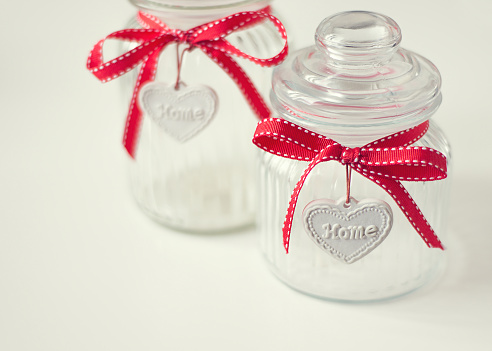 Lovely home jars with red ribbon bows, pastel colors