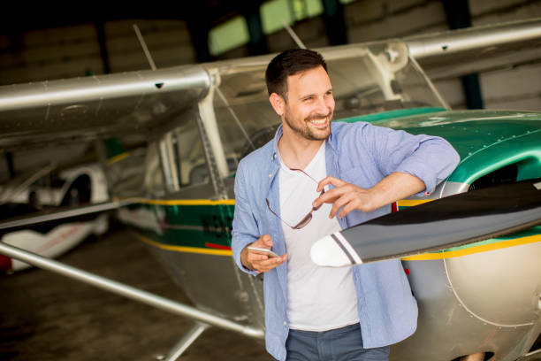 istock Young pilot checking airplane in the hangar 1014238124