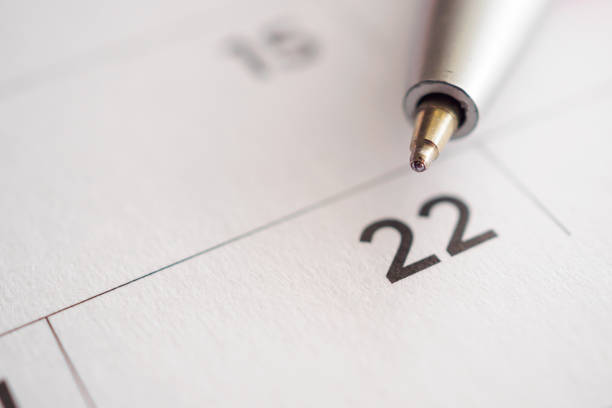 istock Calendar page with pen point at 22nd date 1014238512