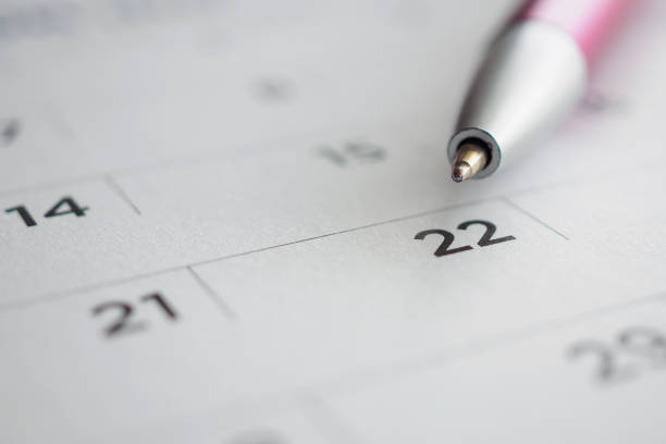 istock Calendar page with pen point at 22nd date 1014238520