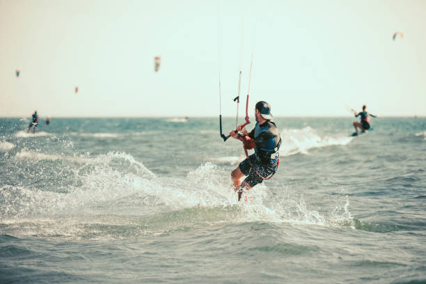 istock Athletic man riding on kite surf board 1014239930