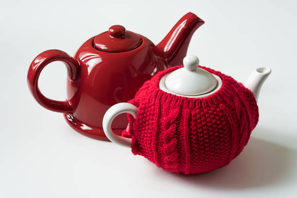 istock Red teapot and red sweater cozy teapot 1014242718