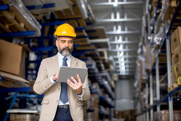 istock Middle-aged businessman with digital tablet in factory 1014243112