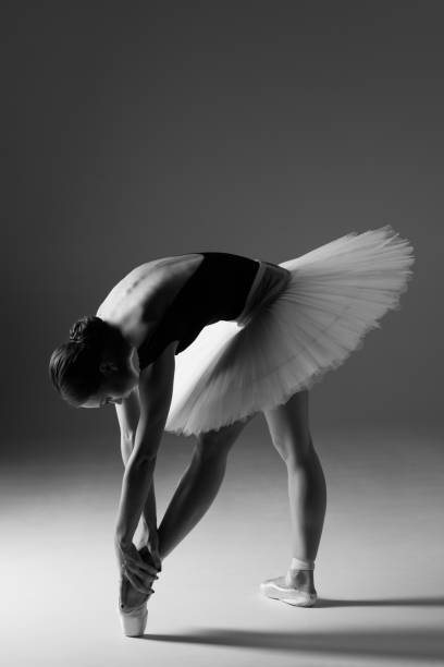 istock Young beautiful ballerina is posing in studio 1014250402