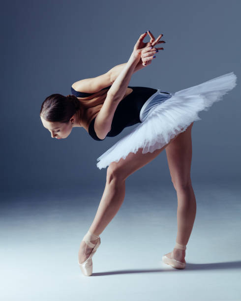 istock Young beautiful ballerina is posing in studio 1014250458