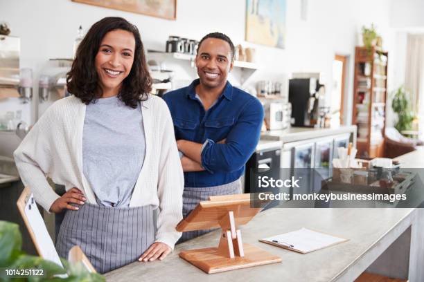 Mixed Race Couple Behind The Counter At Their Coffee Shop Stock Photo - Download Image Now