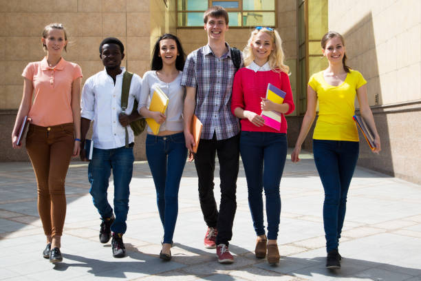 istock Group of diverse students walking together 1014253820