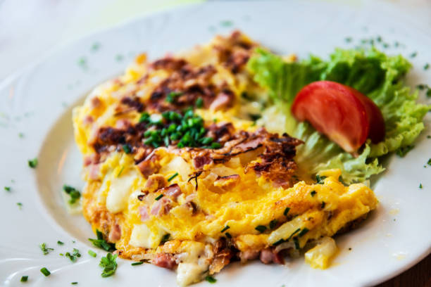 istock omelet with ham tomato and green salad 1014254026