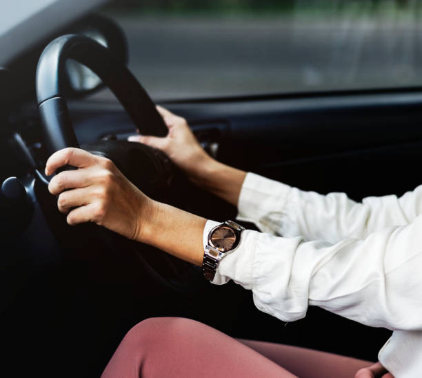 istock Woman driving a car on a road 1014254352