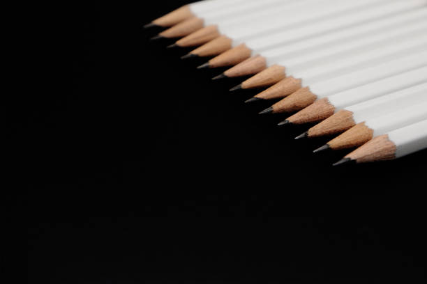istock White pencils on black background with copy space. 1014255874