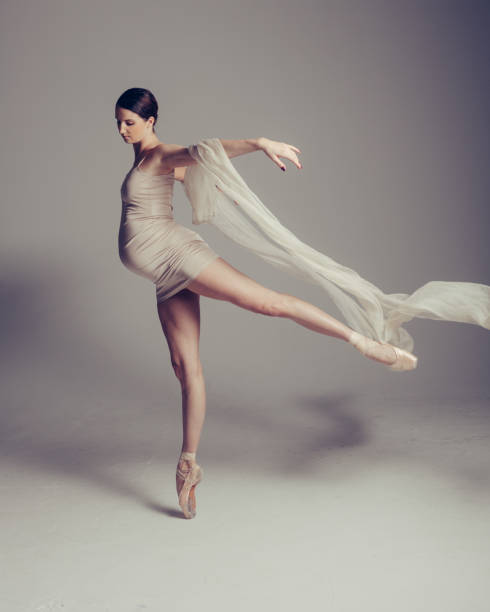 istock Young beautiful pregnant ballerina is posing in studio 1014256846