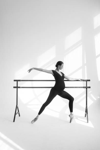 istock Young beautiful pregnant ballerina is posing in studio 1014259982