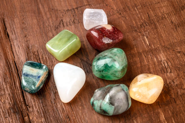 istock Semi precious gemstones on a dark wooden background with copy space 1014260024