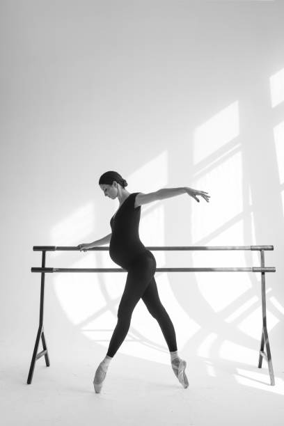 istock Young beautiful pregnant ballerina is posing in studio 1014260770