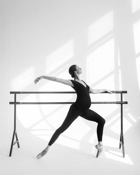 istock Young beautiful pregnant ballerina is posing in studio 1014260822