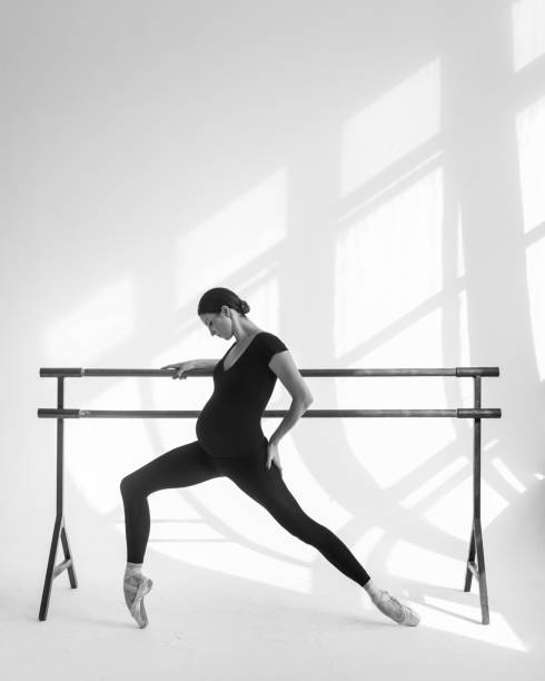 istock Young beautiful pregnant ballerina is posing in studio 1014261296