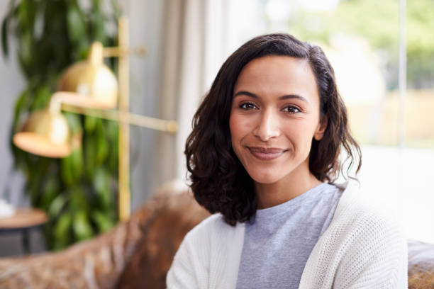 young mixed race woman in coffee shop looking to camera - 30s imagens e fotografias de stock