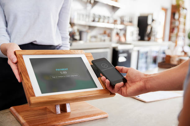 istock Customer making payment by smartphone at cafe, close up 1014270026