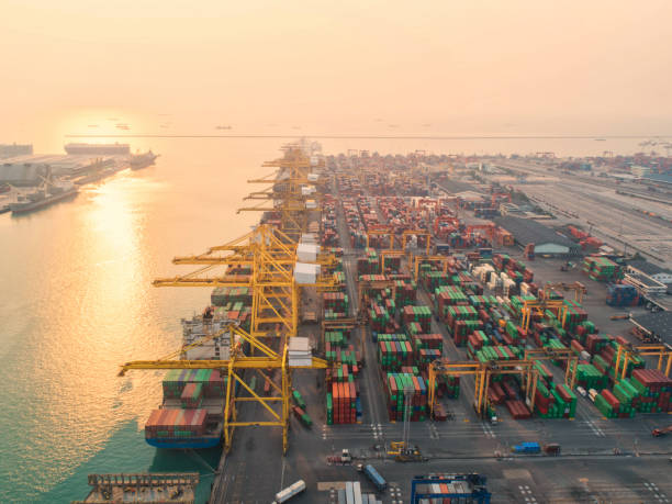 istock Container ship in export and import business and logistics. Shipping cargo to harbor by crane. Water transport International. Aerial view and top view. 1014270122
