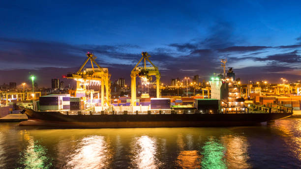 istock Container ship in export and import business and logistics. Shipping cargo to harbor by crane. Water transport International. Aerial view and top view. 1014270508