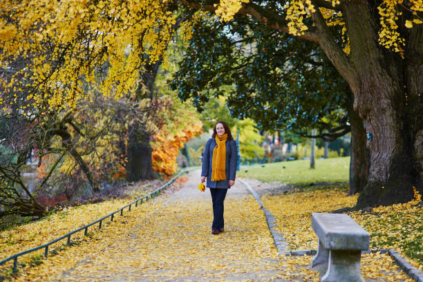 istock Woman walking in park on a bright fall day 1014271660