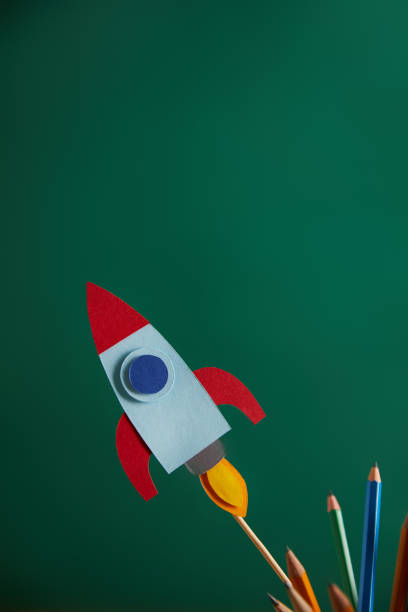 istock pencils and colorful rocket with green chalkboard on background 1014271988