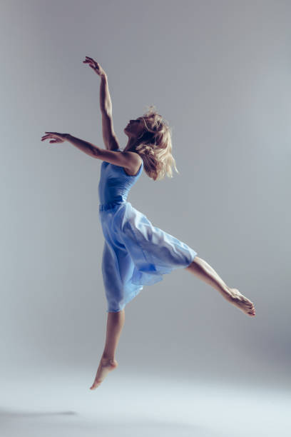 istock Young beautiful ballerina is posing in studio 1014274924
