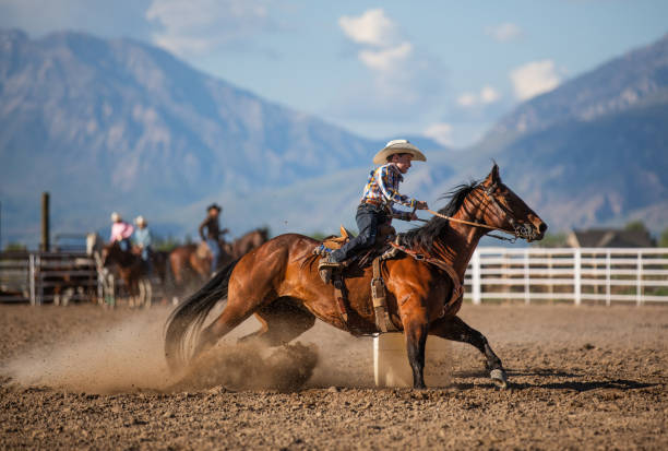istock Young cowboy barrel racing rodeo 1014276036