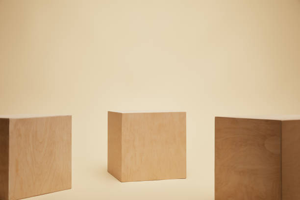 istock three brown wooden cubes isolated on beige 1014276552