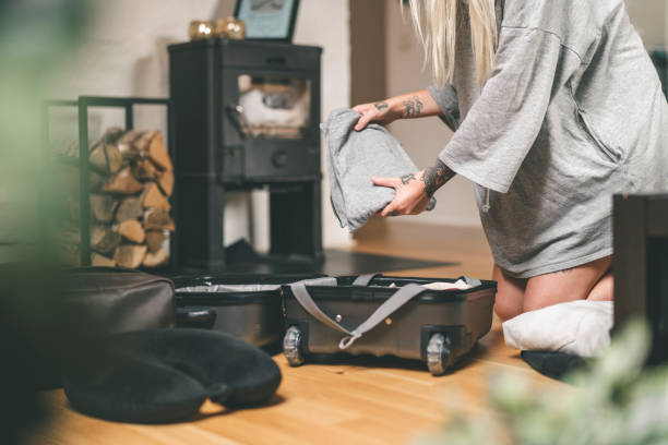istock Tattooed woman packing her suitcase at home 1014280990