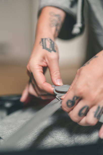 istock Tattooed woman packing her suitcase at home 1014281220